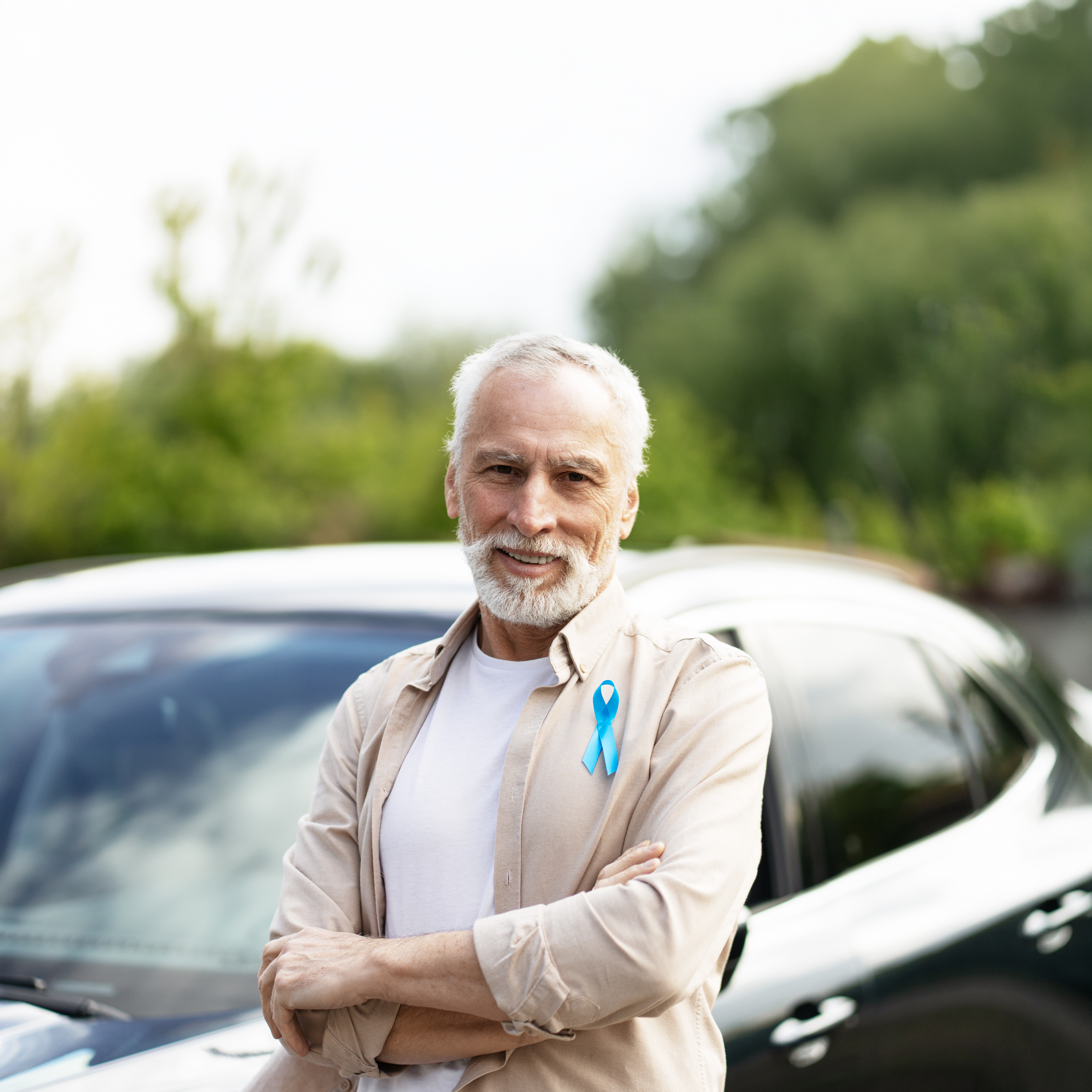 Man posing in front of the car