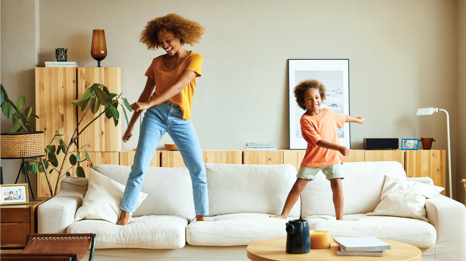 Mother and Daughter Dancing on the Couch